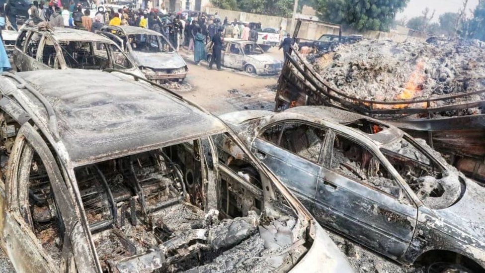 Burnt out vehicles following a sectarian clash in Nigeria