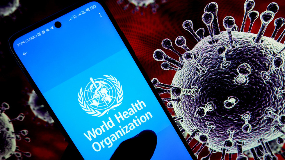 World Health Organization (WHO) logo is seen displayed on an android mobile phone with a covid illustration in the background. © Avishek Das / SOPA Images / LightRocket via Getty Images