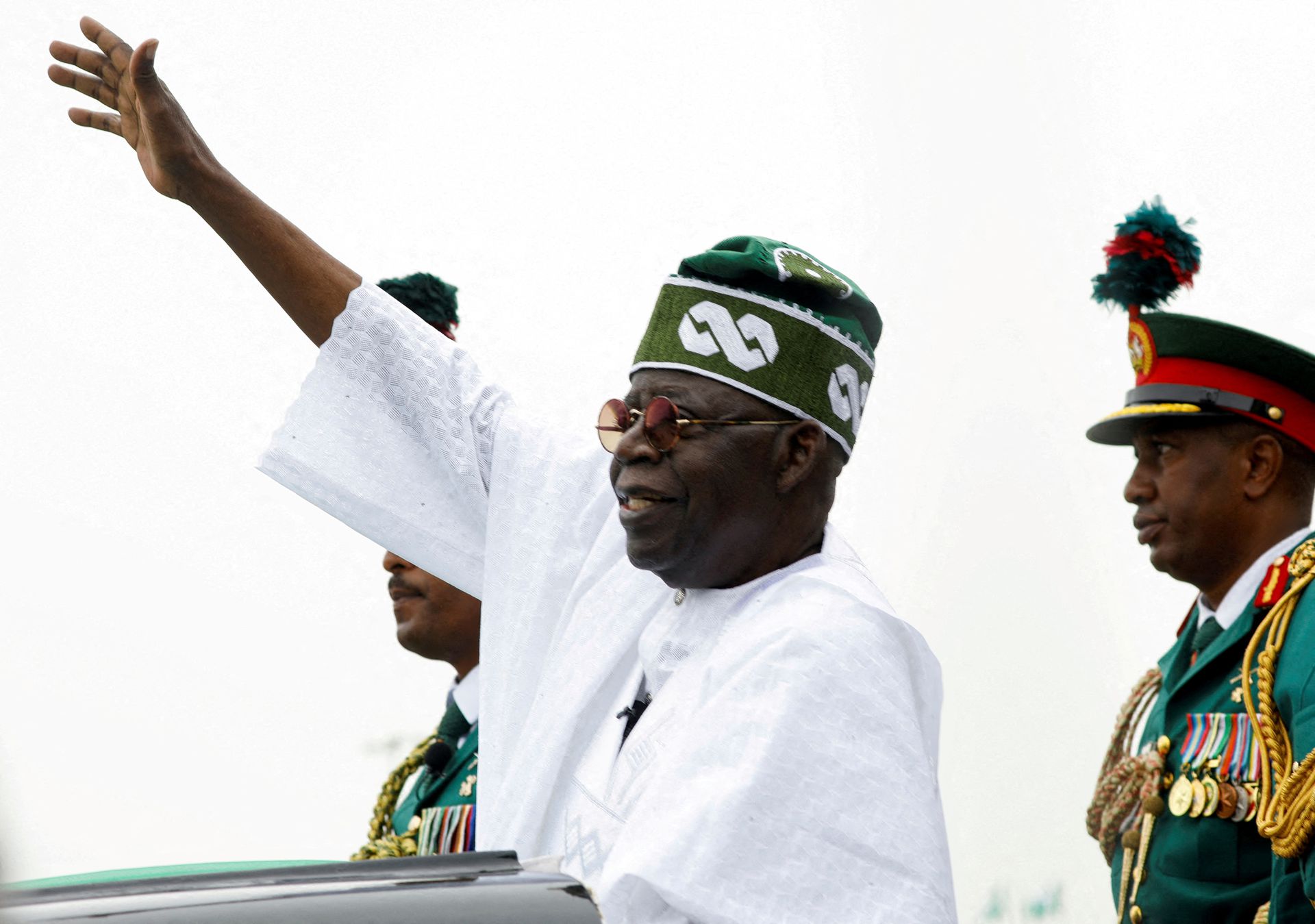 Nigeria's President Bola Tinubu waves to a crowd as he takes the traditional ride on top of a ceremonial vehicle, after his swearing-in ceremony in Abuja, Nigeria May 29, 2023. REUTERS/Temilade Adelaja/File Photo