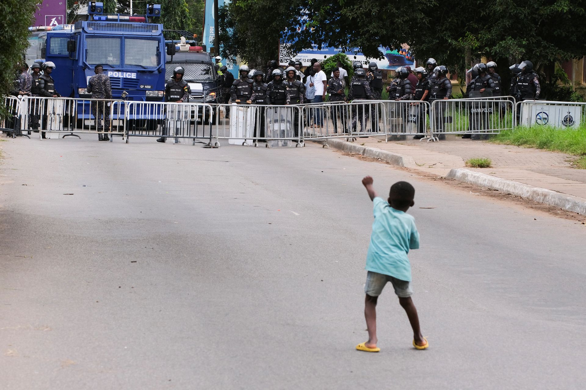 A young boy gestures at the police as demonstrators gather in the streets for a third day of anti-government protests in Accra, Ghana, September 23, 2023. REUTERS/Francis Kokoroko